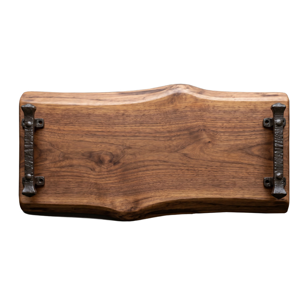 A rustic live-edge charcuterie wooden serving tray with dark metal handles on both sides, shown against a plain white background.